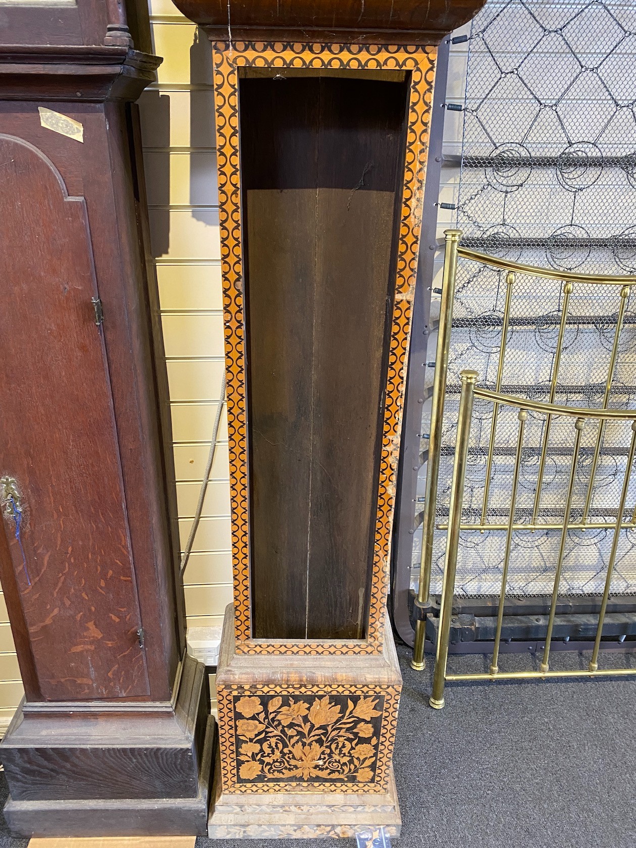 A George III oak longcase clock case and an inlaid clock case, larger 222 cm high.